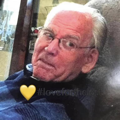 Elderly man with glasses, smiling slightly while looking towards the camera.